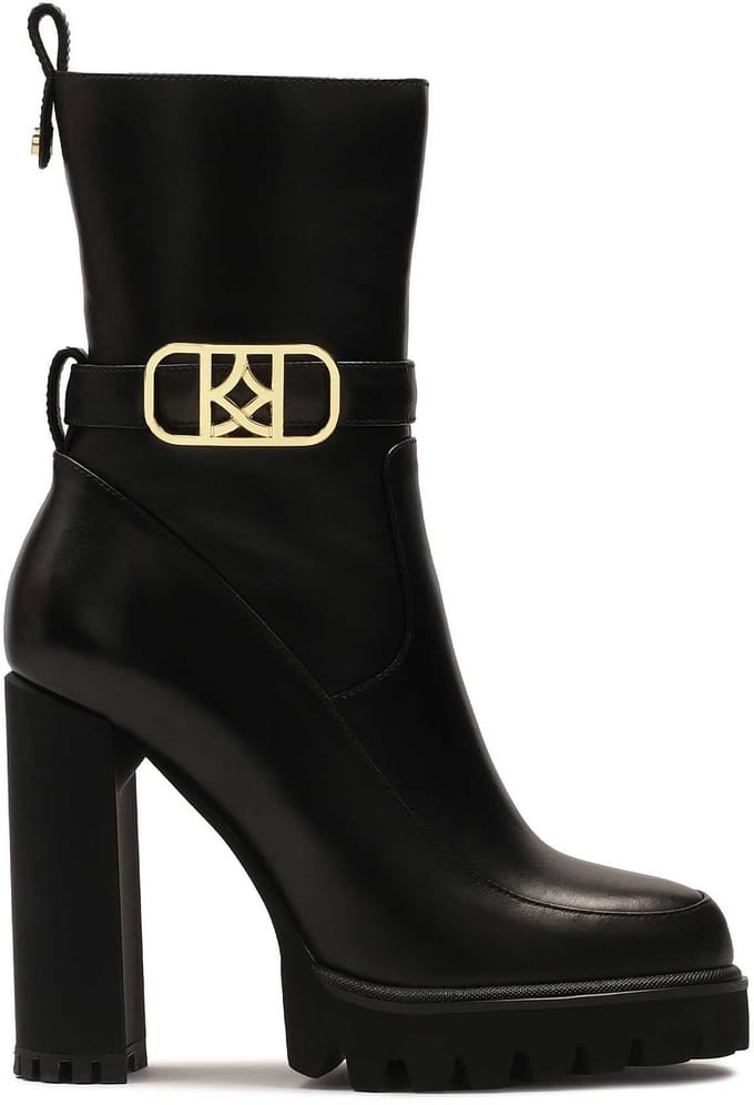 Black monogrammed KAZAR boots set on a post